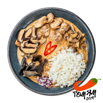 Soup Tom Yam with mushrooms, chicken and stewed rice